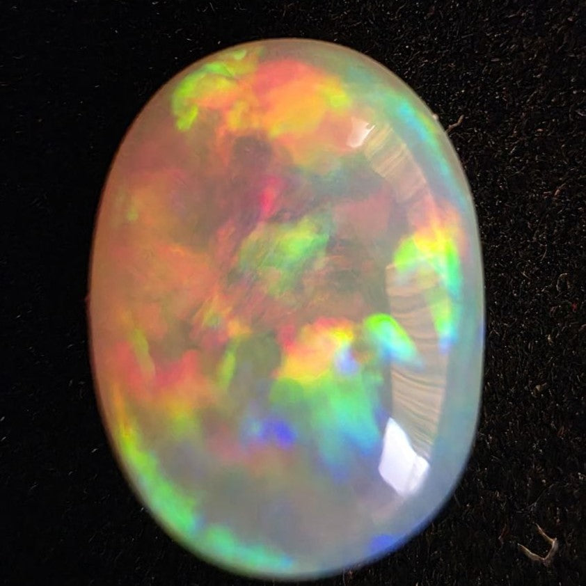 White Opal special Ethiopian Welo, 5.4 ct oval polished, natural, intense Play-of-Colour