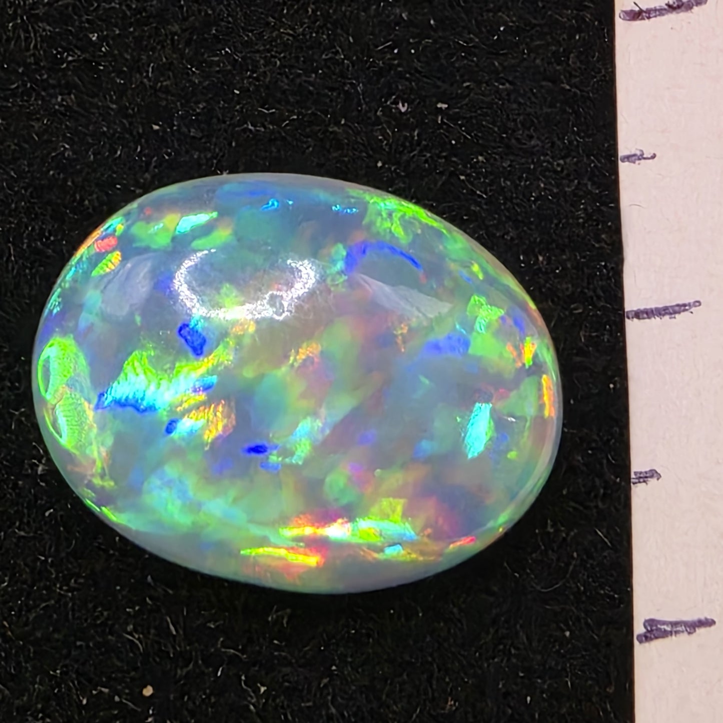 White Opal special Ethiopian Welo, 7.05 ct oval polished, natural, intense Play-of-Colour