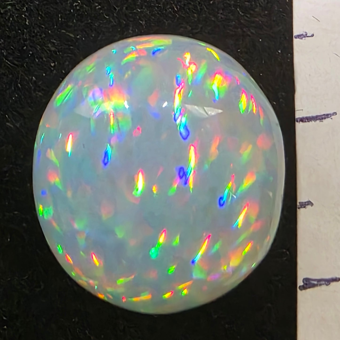 White Opal special Ethiopian Welo, 8.8 ct oval polished, natural, intense Play-of-Colour