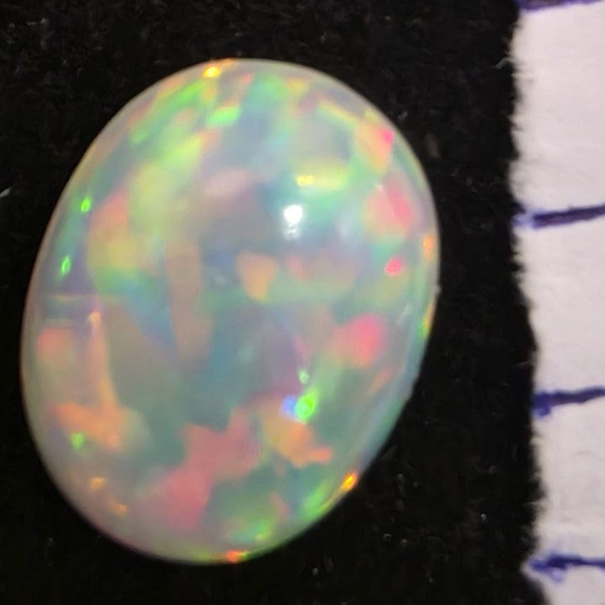 White Opal special Ethiopian Welo, 6.35 ct oval polished, natural, intense Play-of-Colour