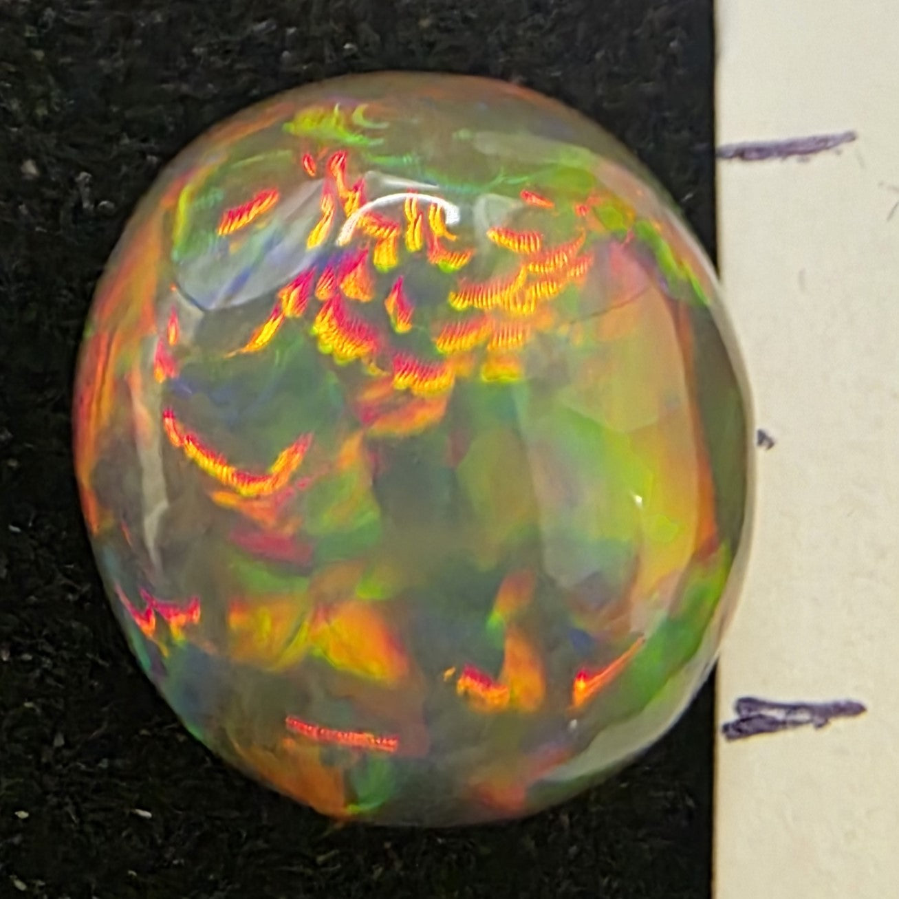 Black Opal special Ethiopian Welo, 4.4 ct freeform polished, natural, intense Play-of-Colour
