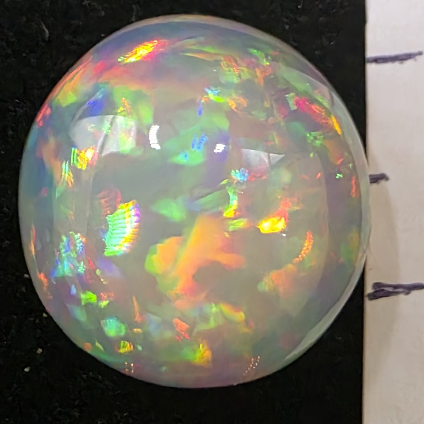 White Opal special Ethiopian Welo, 11.2 ct round polished, natural, intense Play-of-Colour