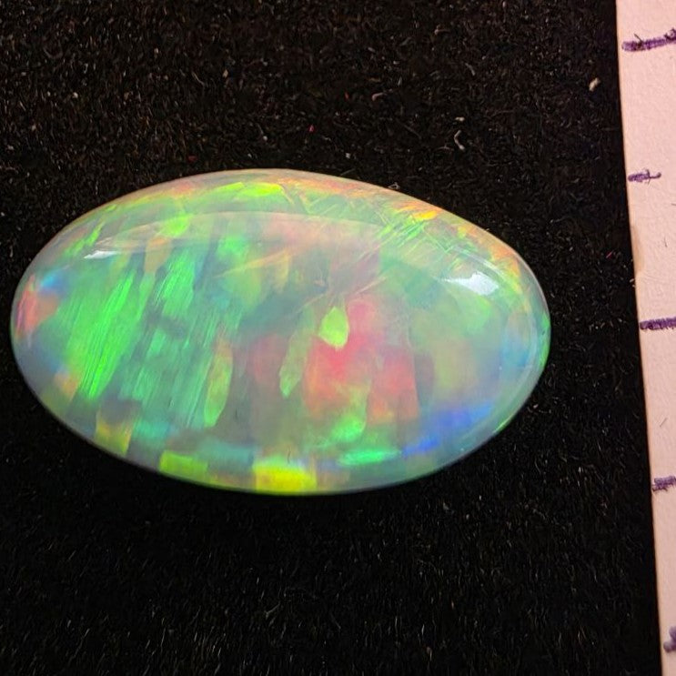 White Opal special Ethiopian Welo, 5.3 ct oval polished, natural, intense Play-of-Colour