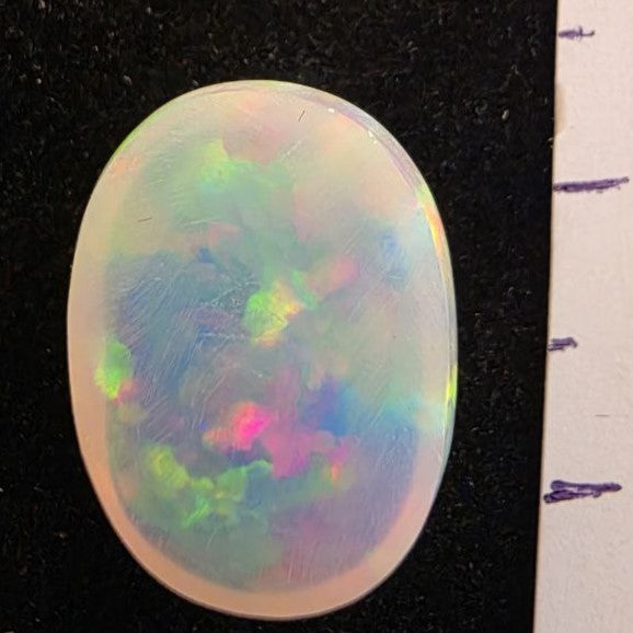 White Opal special Ethiopian Welo, 5.4 ct oval polished, natural, intense Play-of-Colour