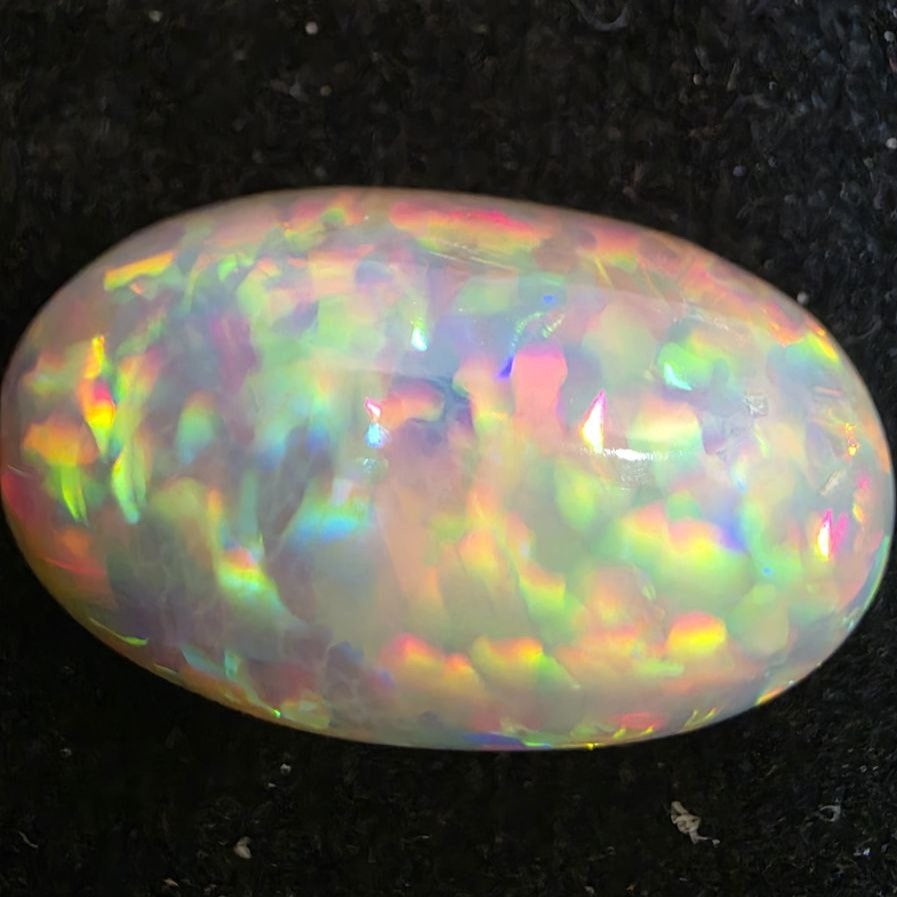 White Opal special Ethiopian Welo, 11.55 ct oval polished, natural, intense Play-of-Colour