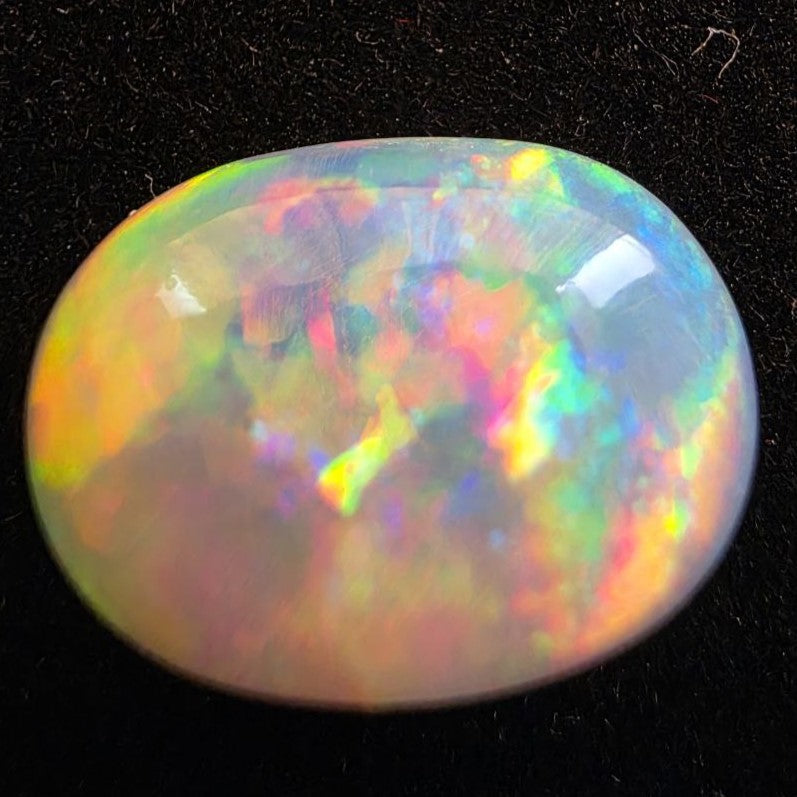 White Opal special Ethiopian Welo, 5.4 ct oval polished, natural, intense Play-of-Colour