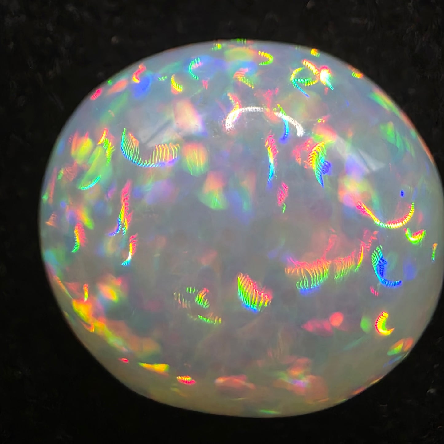 White Opal special Ethiopian Welo, 8.8 ct oval polished, natural, intense Play-of-Colour
