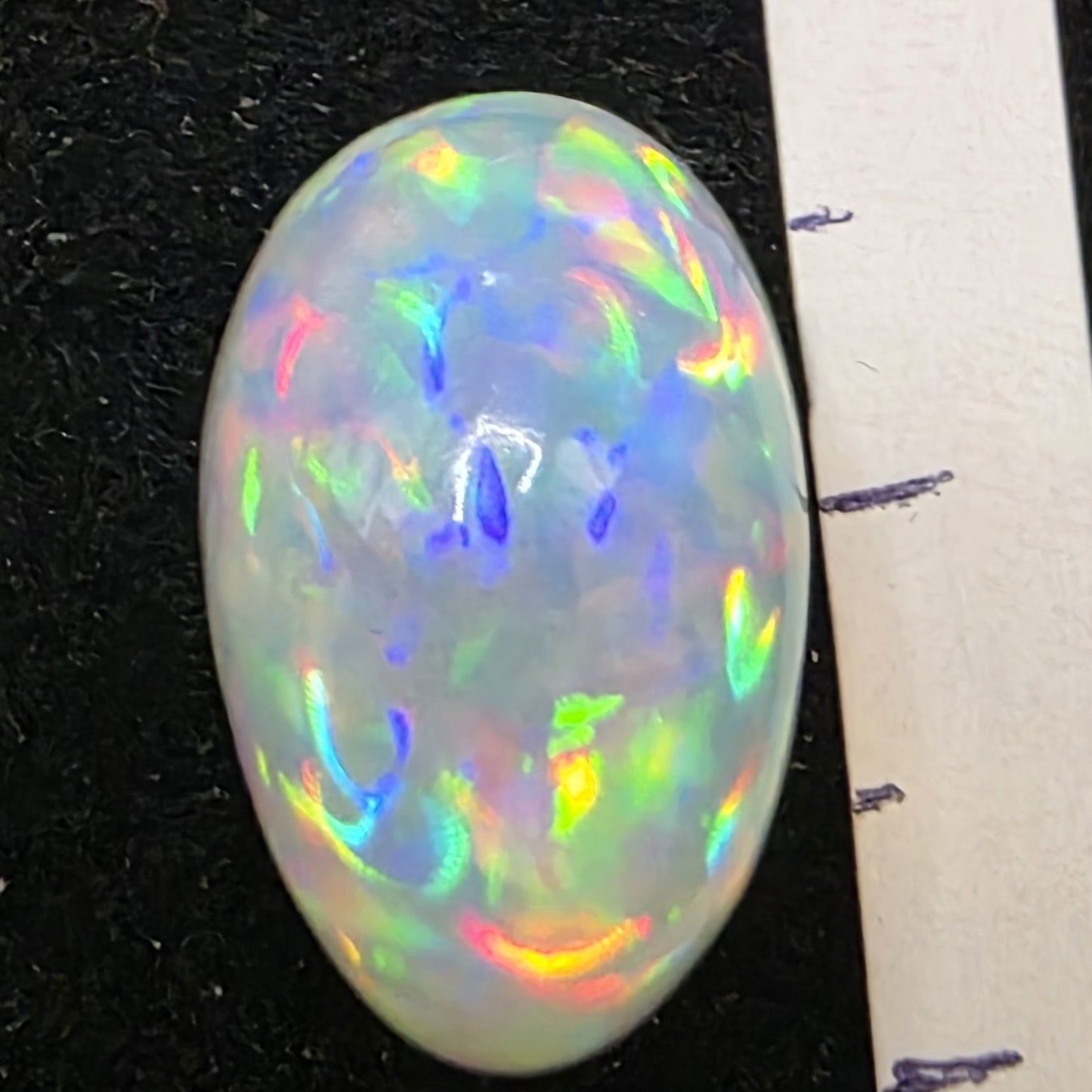 White Opal special Ethiopian Welo, 7.85 ct oval polished, natural, intense Play-of-Colour
