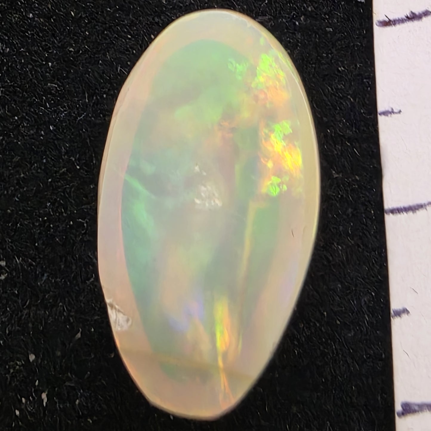 White Opal special Ethiopian Welo, 6.9 ct oval polished, natural, intense Play-of-Colour