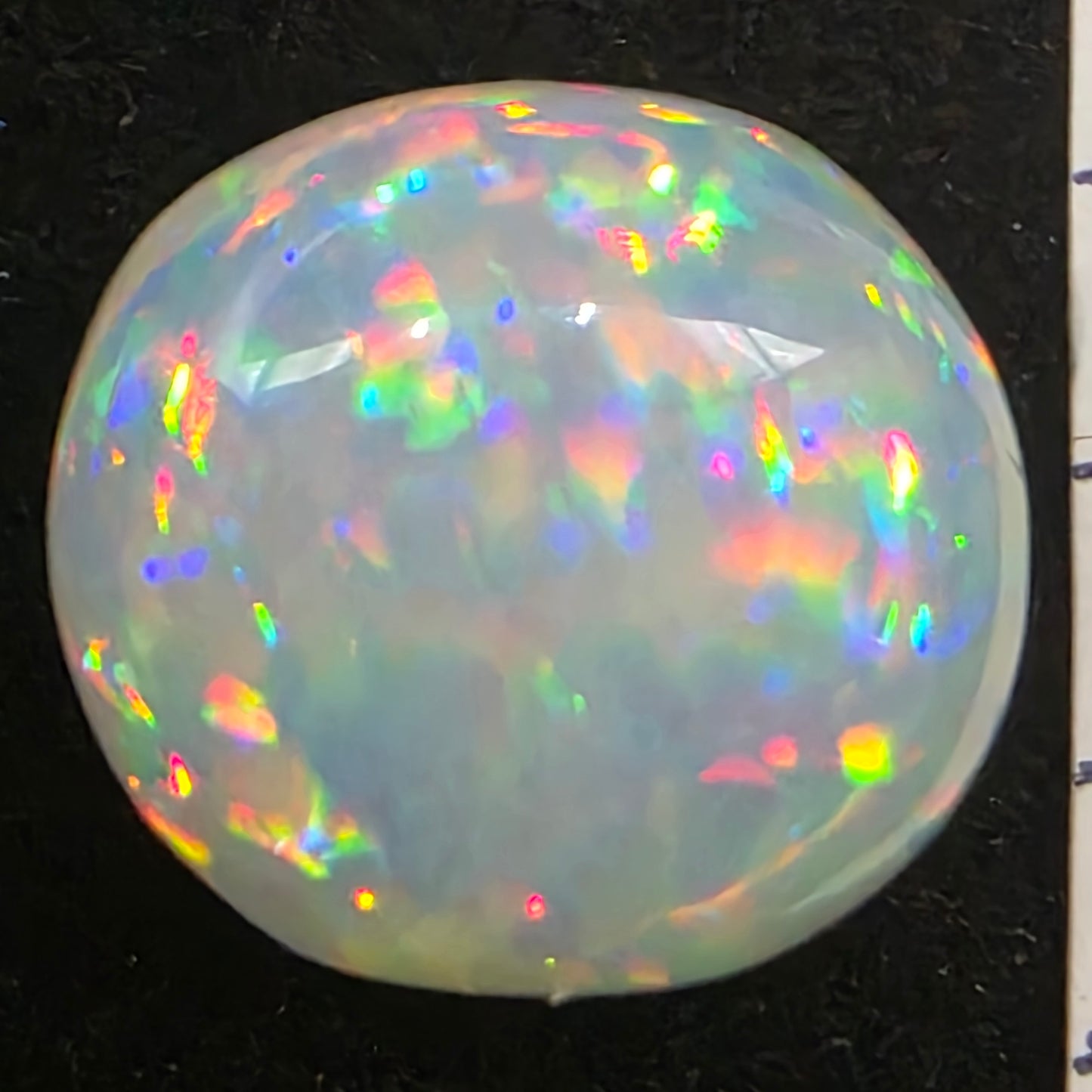 White Opal special Ethiopian Welo, 8.8 ct oval polished, natural, intense Play-of-Colour
