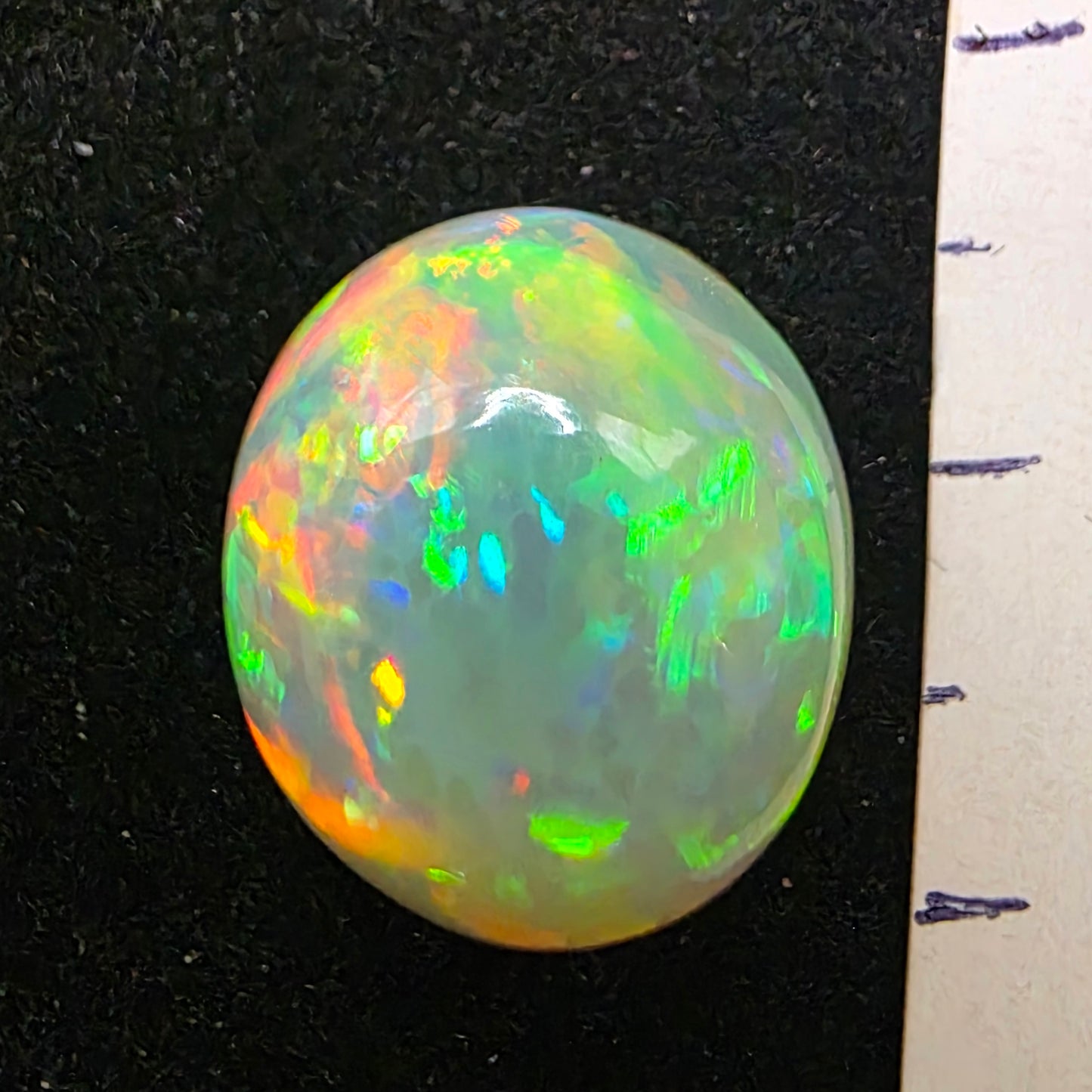 White Opal special Ethiopian Welo, 8.9 ct oval polished, natural, intense Play-of-Colour