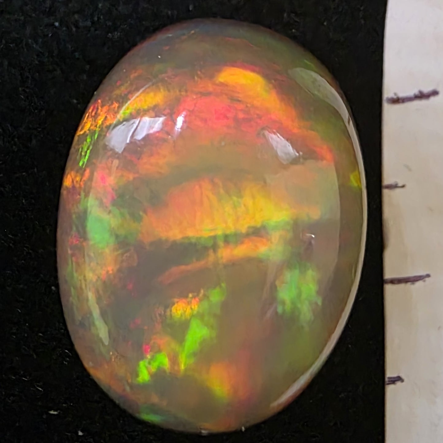 Black Opal special Ethiopian Welo, 21.2 ct oval polished, natural, intense Play-of-Colour