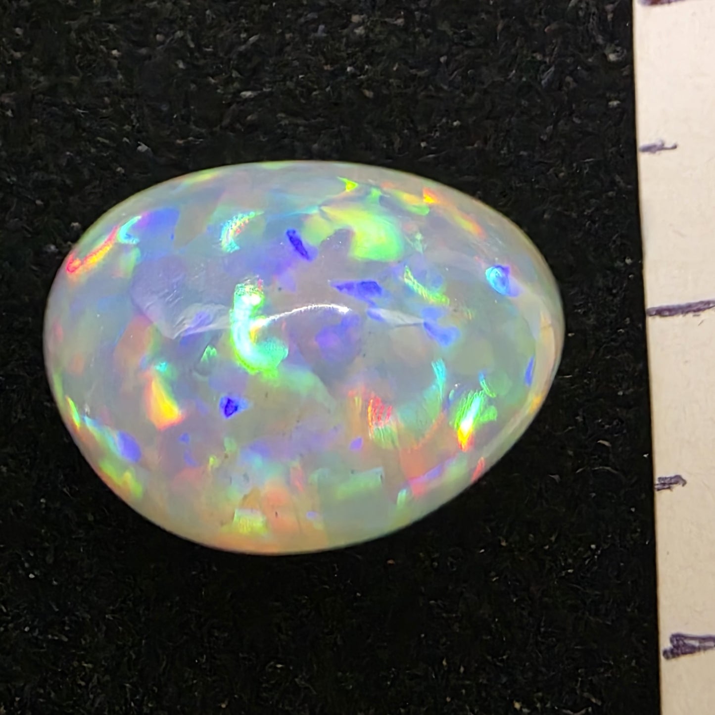White Opal special Ethiopian Welo, 7.85 ct oval polished, natural, intense Play-of-Colour
