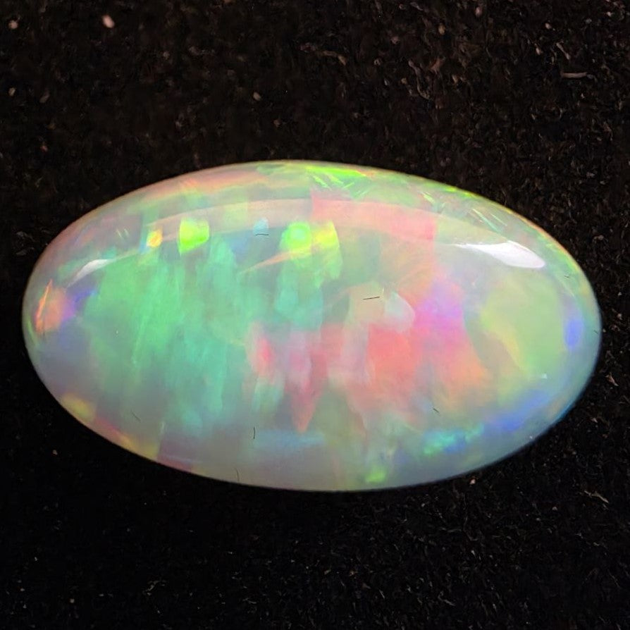 White Opal special Ethiopian Welo, 5.3 ct oval polished, natural, intense Play-of-Colour