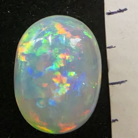 White Opal special Ethiopian Welo, 5.4 ct oval polished, natural, intense Play-of-Colour