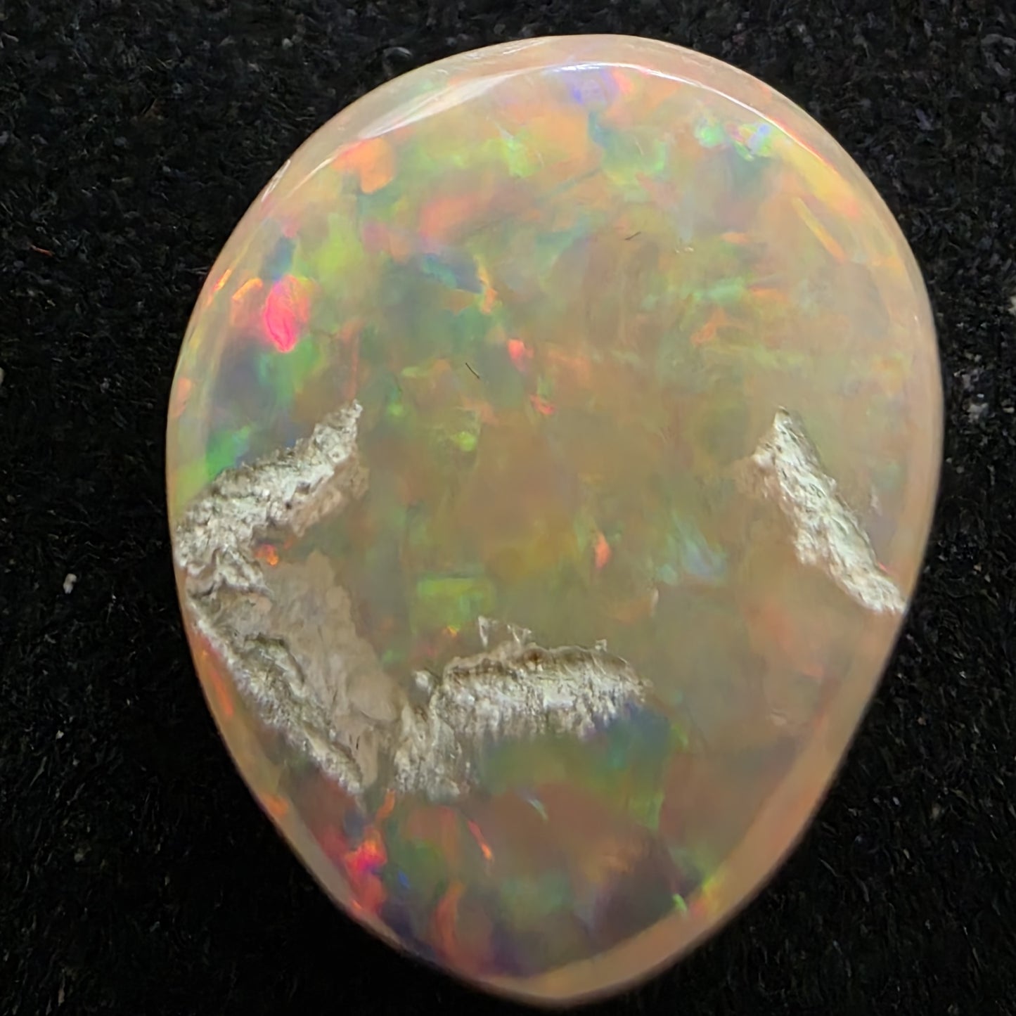 White Opal special Ethiopian Welo, 6.85 ct oval polished, natural, intense Play-of-Colour