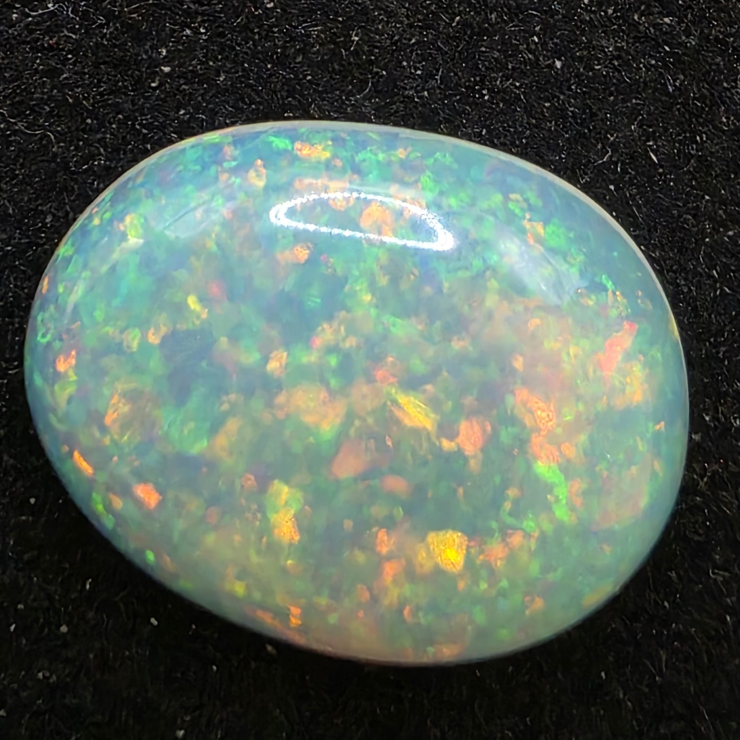 White Opal special Ethiopian Welo, 6.7 ct oval polished, natural, intense Play-of-Colour