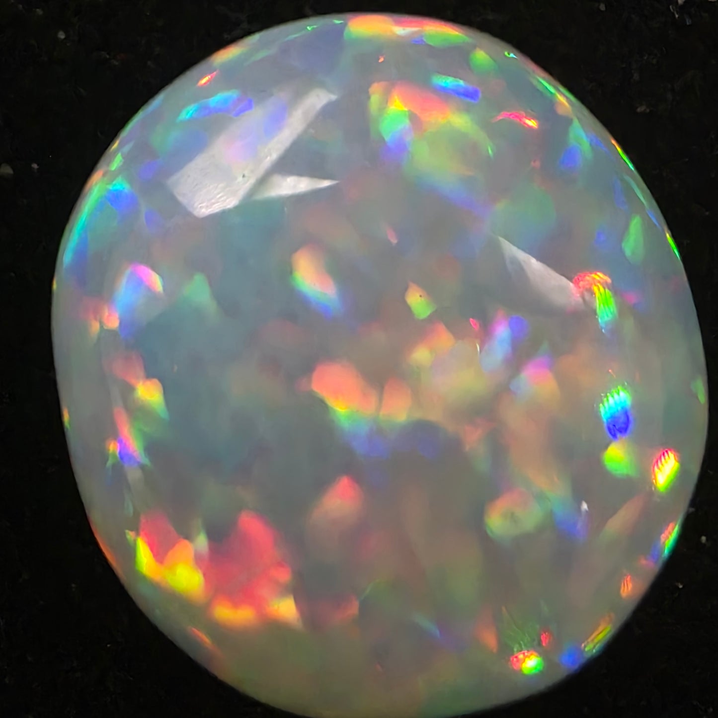 White Opal special Ethiopian Welo, 8.8 ct oval polished, natural, intense Play-of-Colour
